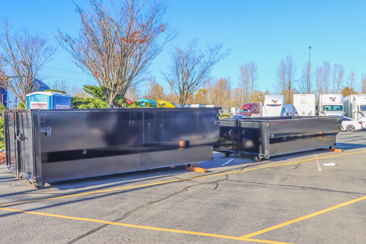 Professional dumpster rental service with roll-off container on residential driveway in Hackensack